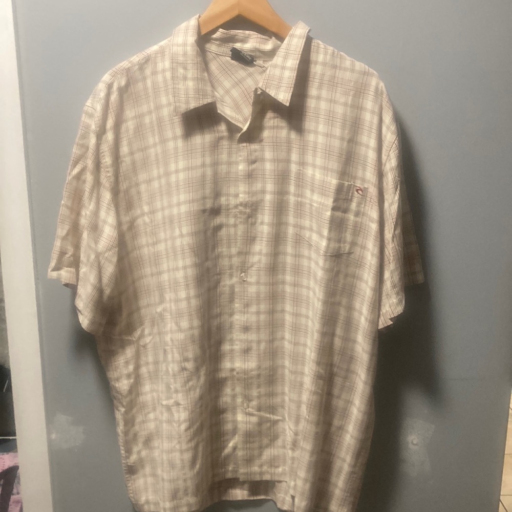 Rip curl short, sleeved button down cream with red and black lines pattern on it